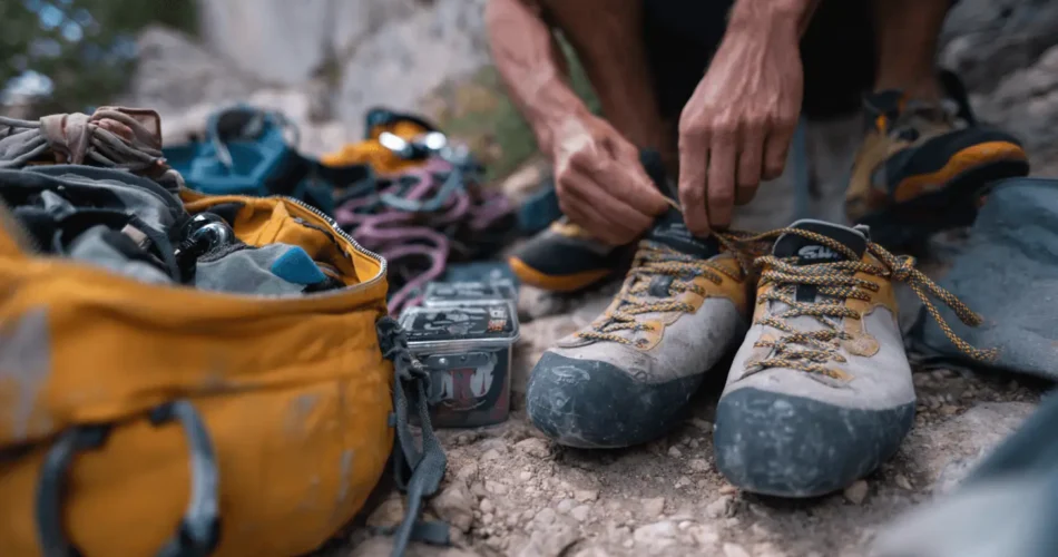 a man tying a climbing shoes